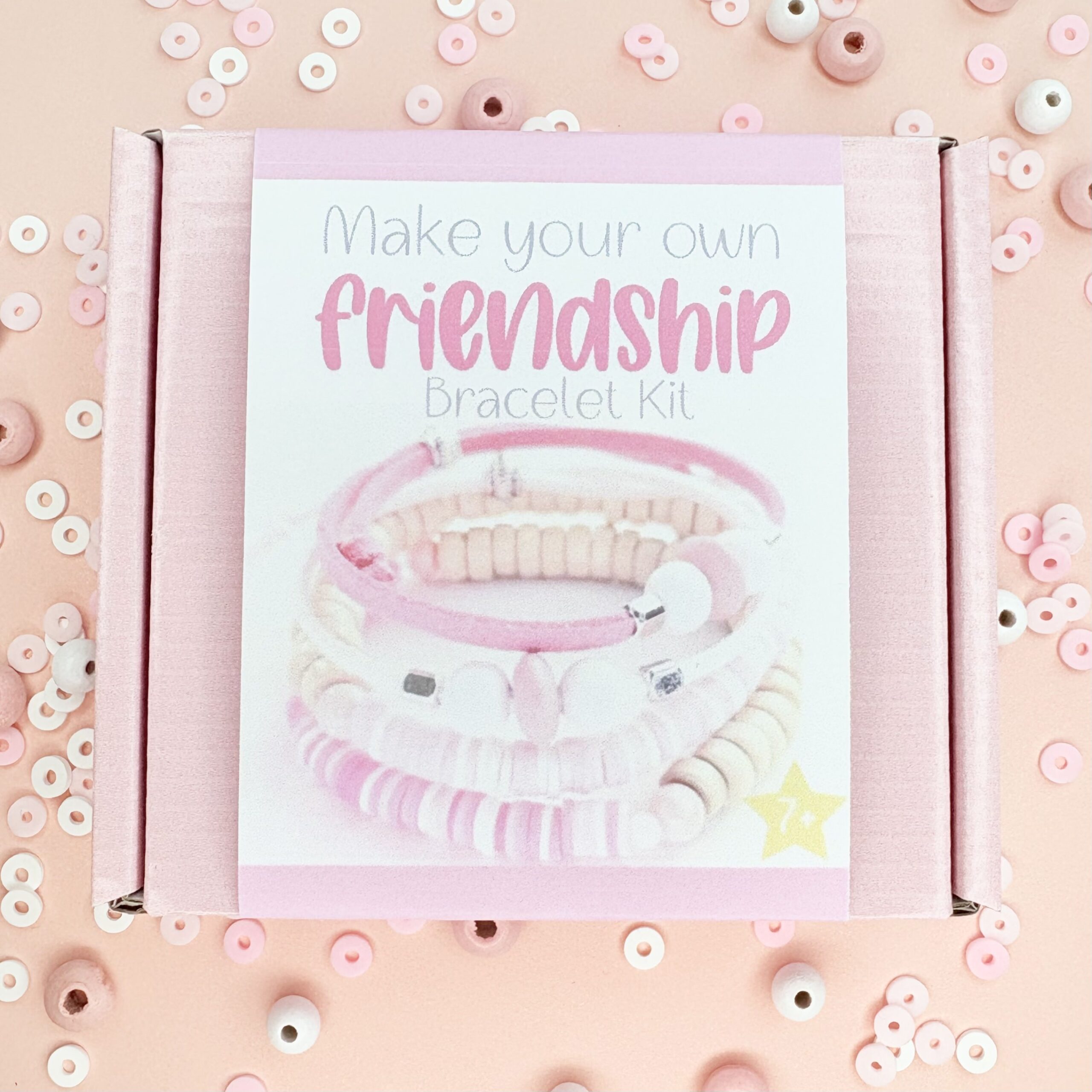Flower Town Packaging Pink Box with white label surrounded by beads