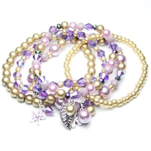 Five beaded bracelets in purple and gold colour with silver leaf charms