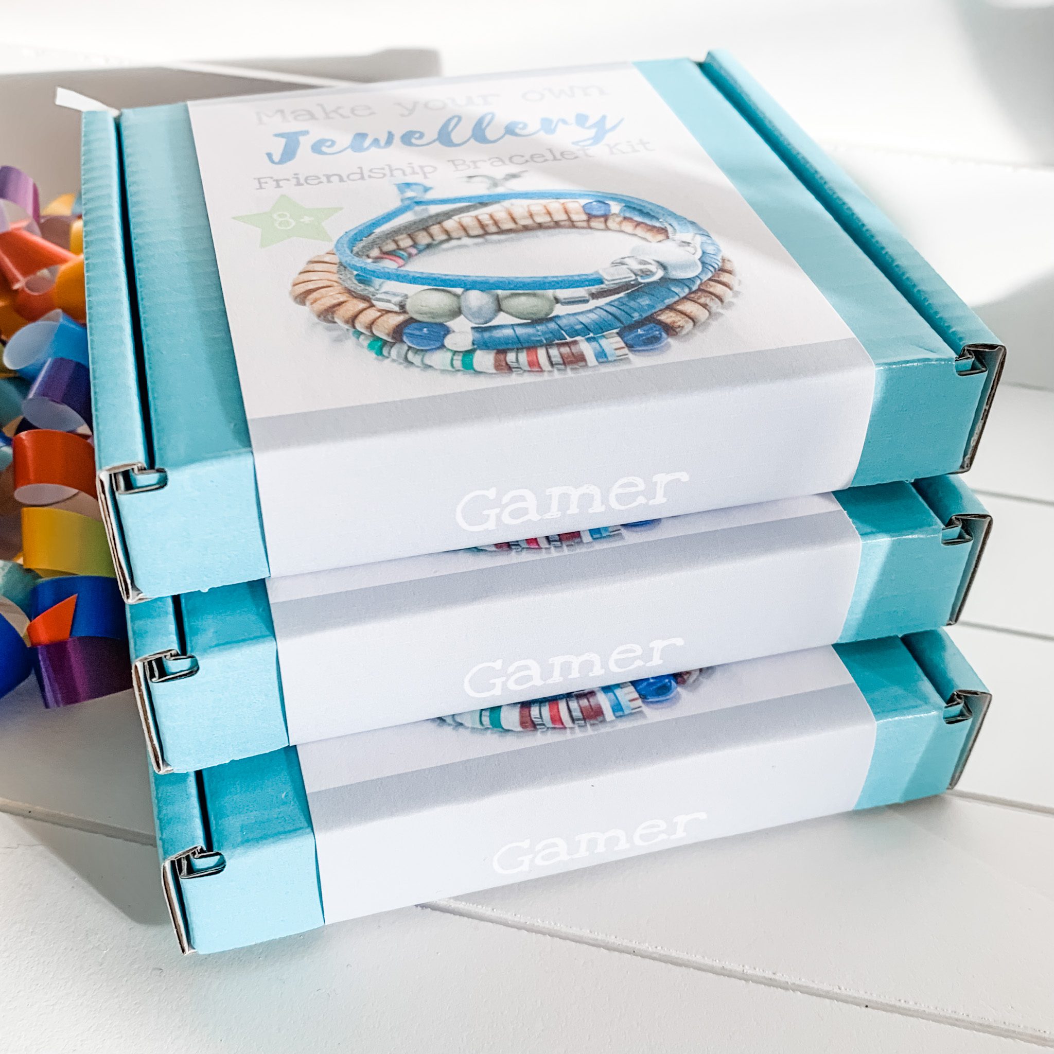 Gamer Bracelet Making Kit Stack of three blue boxed Gamer kits with white labels