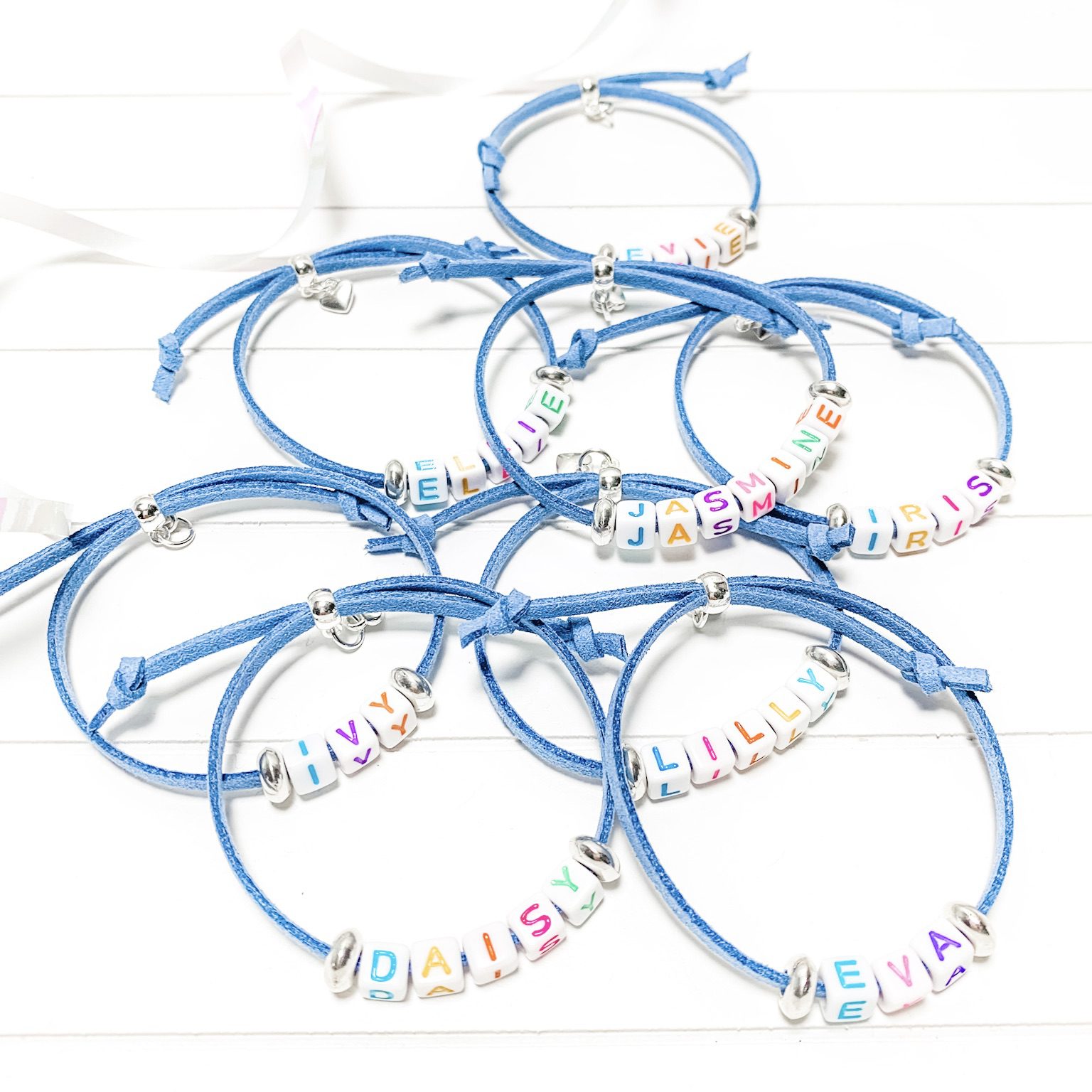 Personalised Friendship Bracelets A bundle of blue suede cord bracelets with letter bead names