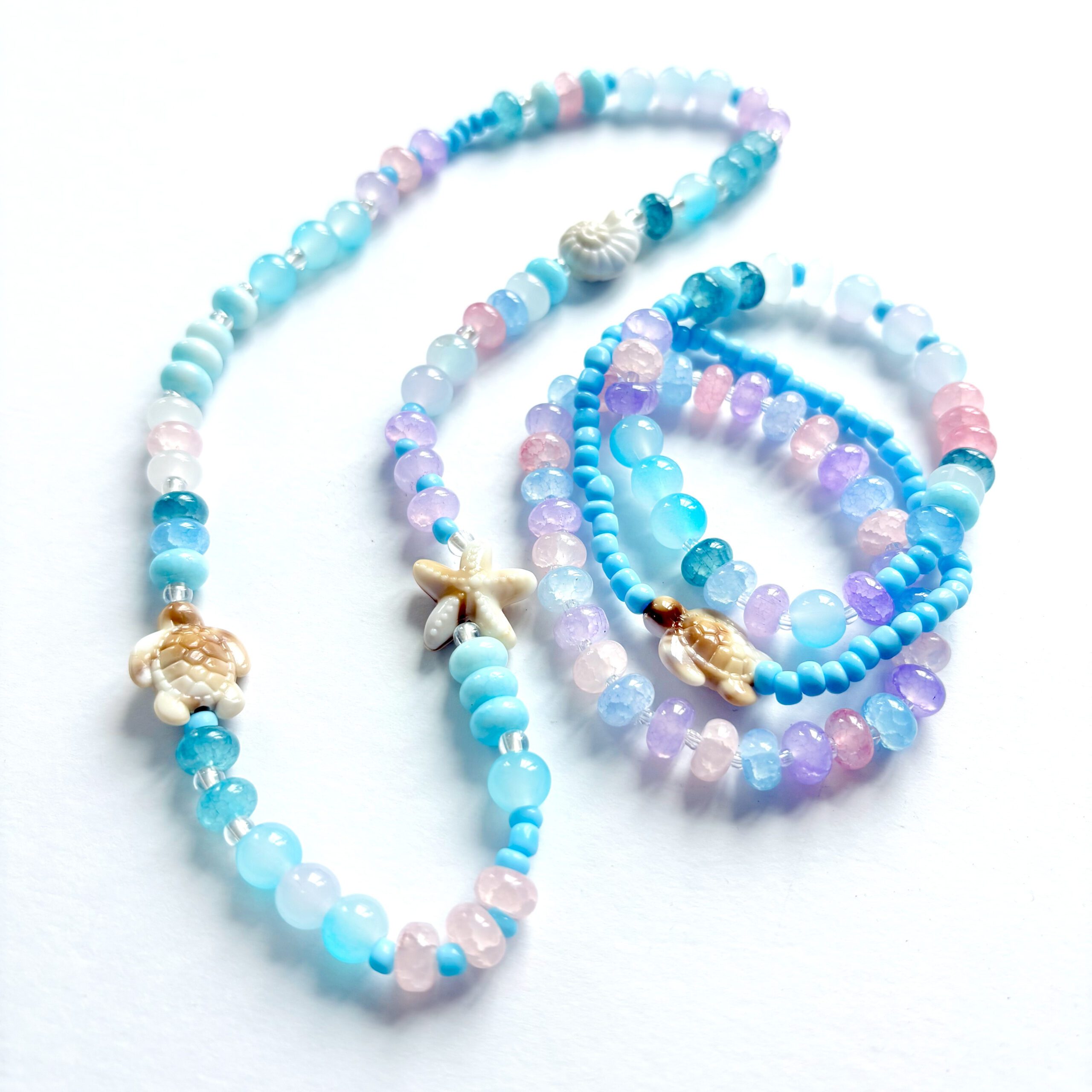 Sea Creatures an ocean themed jewellery set with a necklace and three bracelets in pink, blue and purple colours