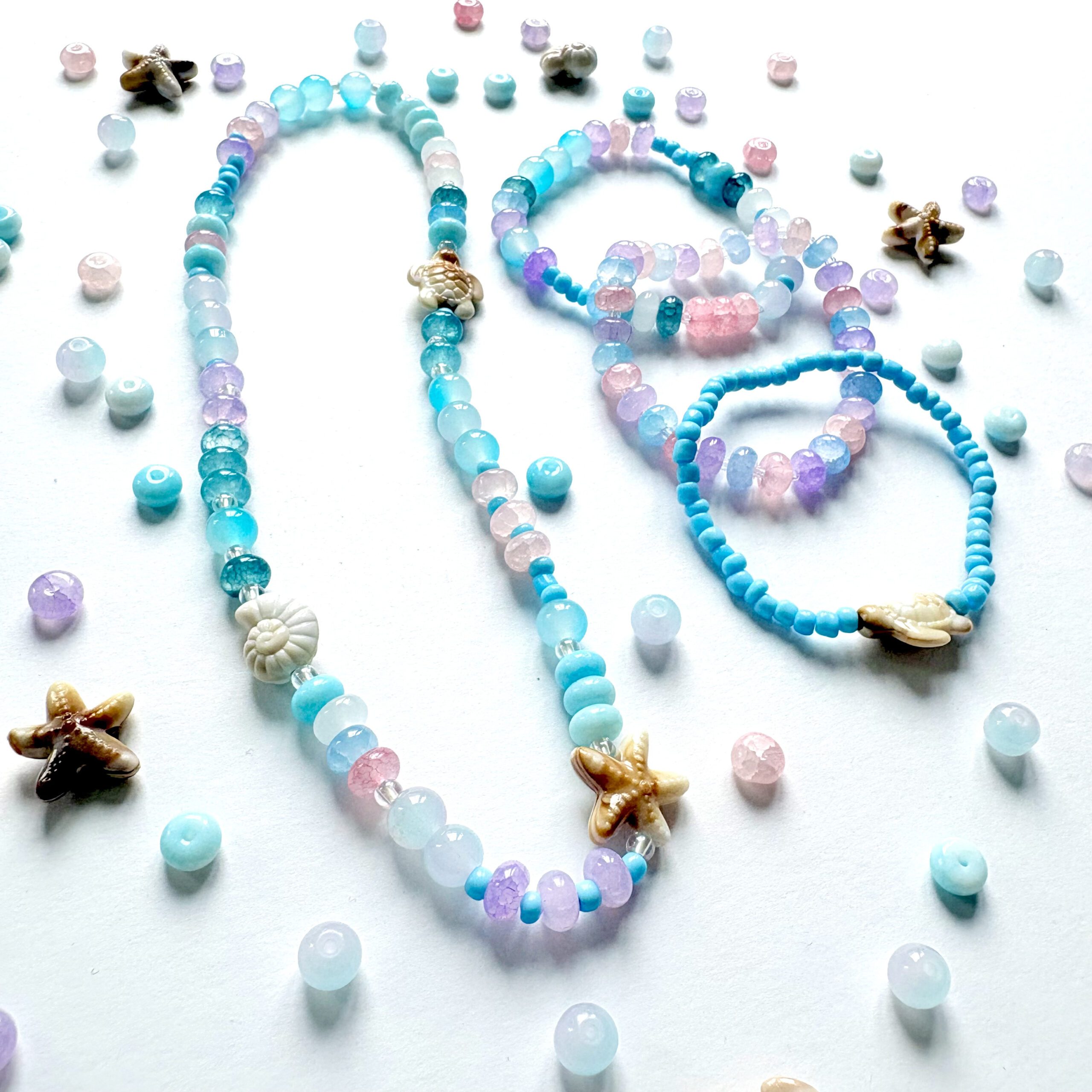 Sea Creatures an ocean themed jewellery set with a necklace and three bracelets in pink, blue and purple colours